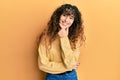 Young hispanic girl wearing casual clothes looking confident at the camera smiling with crossed arms and hand raised on chin Royalty Free Stock Photo