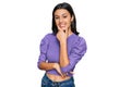 Young hispanic girl wearing casual clothes looking confident at the camera smiling with crossed arms and hand raised on chin Royalty Free Stock Photo