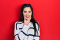 Young hispanic girl wearing casual clothes looking confident at the camera smiling with crossed arms and hand raised on chin Royalty Free Stock Photo