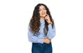 Young hispanic girl wearing casual clothes looking confident at the camera smiling with crossed arms and hand raised on chin Royalty Free Stock Photo