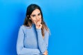 Young hispanic girl wearing casual clothes looking confident at the camera smiling with crossed arms and hand raised on chin Royalty Free Stock Photo