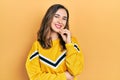 Young hispanic girl wearing casual clothes looking confident at the camera smiling with crossed arms and hand raised on chin Royalty Free Stock Photo