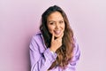 Young hispanic girl wearing casual clothes looking confident at the camera smiling with crossed arms and hand raised on chin Royalty Free Stock Photo