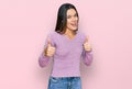 Young hispanic girl wearing casual clothes success sign doing positive gesture with hand, thumbs up smiling and happy Royalty Free Stock Photo