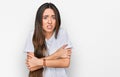 Young hispanic girl wearing casual white t shirt shaking and freezing for winter cold with sad and shock expression on face Royalty Free Stock Photo