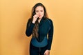 Young hispanic girl wearing diver neoprene uniform mouth and lips shut as zip with fingers