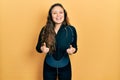 Young hispanic girl wearing diver neoprene uniform success sign doing positive gesture with hand, thumbs up smiling and happy Royalty Free Stock Photo