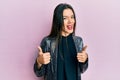 Young hispanic girl wearing party jacket success sign doing positive gesture with hand, thumbs up smiling and happy Royalty Free Stock Photo