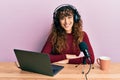 Young hispanic girl working at radio office happy face smiling with crossed arms looking at the camera