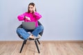 Young hispanic girl working using computer laptop looking at the watch time worried, afraid of getting late Royalty Free Stock Photo