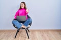 Young hispanic girl working using computer laptop pointing to you and the camera with fingers, smiling positive and cheerful Royalty Free Stock Photo