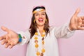 Young hispanic hippie woman wearing fashion boho style and sunglasses over pink background looking at the camera smiling with open Royalty Free Stock Photo