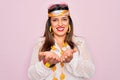 Young hispanic hippie woman wearing fashion boho style and sunglasses over pink background Smiling with hands palms together Royalty Free Stock Photo