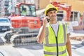 Young hispanic man architect smiling confident talking on smartphone at park Royalty Free Stock Photo