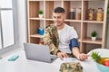 Young hispanic man army soldier using tensiometer at home