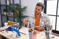 Young hispanic man artist having video call drawing at art studio