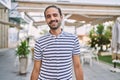 Young hispanic man with beard outdoors at the city winking looking at the camera with sexy expression, cheerful and happy face Royalty Free Stock Photo