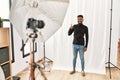 Young hispanic man with beard posing as model at photography studio doing happy thumbs up gesture with hand Royalty Free Stock Photo