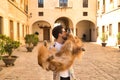 Young Hispanic man with beard and sunglasses kissing his dog which he is holding in his arms very happy. Concept animals, dogs, Royalty Free Stock Photo