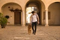 Young Hispanic man with beard and sunglasses walking with his dog very happy. Concept animals, dogs, love, pets, golden Royalty Free Stock Photo