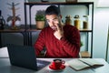 Young hispanic man with beard using computer laptop at night at home pointing to the eye watching you gesture, suspicious Royalty Free Stock Photo