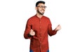 Young hispanic man with beard wearing business shirt and glasses excited for success with arms raised and eyes closed celebrating Royalty Free Stock Photo