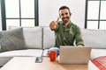 Young hispanic man with beard wearing call center agent headset working from home approving doing positive gesture with hand, Royalty Free Stock Photo