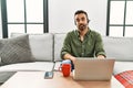 Young hispanic man with beard wearing call center agent headset working from home looking sleepy and tired, exhausted for fatigue Royalty Free Stock Photo