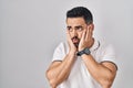 Young hispanic man with beard wearing casual clothes over white background tired hands covering face, depression and sadness, Royalty Free Stock Photo