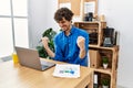Young hispanic man with beard working at the office using computer laptop very happy and excited doing winner gesture with arms Royalty Free Stock Photo