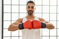 Young hispanic man boxing at sport center Royalty Free Stock Photo