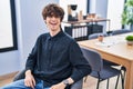 Young hispanic man business worker smiling confident sitting on chair at office Royalty Free Stock Photo