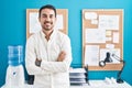 Young hispanic man business worker smiling confident standing with arms crossed gesture at office Royalty Free Stock Photo