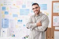 Young hispanic man business worker smiling confident standing with arms crossed gesture at office Royalty Free Stock Photo