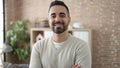 Young hispanic man business worker smiling confident standing with arms crossed gesture at office Royalty Free Stock Photo