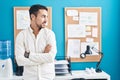 Young hispanic man business worker smiling confident standing with arms crossed gesture at office Royalty Free Stock Photo