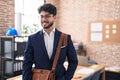 Young hispanic man business worker smiling confident standing at office Royalty Free Stock Photo