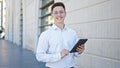 Young hispanic man business worker smiling confident using touchpad at hospital Royalty Free Stock Photo