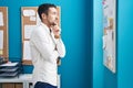 Young hispanic man business worker standing with arms crossed gesture at office Royalty Free Stock Photo