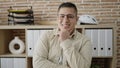 Young hispanic man business worker standing with arms crossed gesture at office Royalty Free Stock Photo