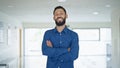 Young hispanic man business worker standing with arms crossed gesture at the office Royalty Free Stock Photo