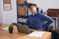 Young hispanic man business worker suffering for backache at office Royalty Free Stock Photo