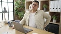 Young hispanic man business worker suffering for backache at office Royalty Free Stock Photo