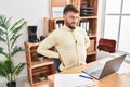 Young hispanic man business worker suffering for backache working at office Royalty Free Stock Photo