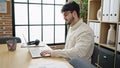 Young hispanic man business worker suffering for backache working at office Royalty Free Stock Photo