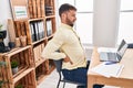 Young hispanic man business worker suffering for backache working at office Royalty Free Stock Photo