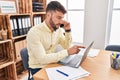 Young hispanic man business worker talking on the smartphone working at office Royalty Free Stock Photo