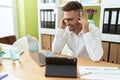 Young hispanic man call center agent working at office Royalty Free Stock Photo