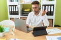 Young hispanic man call center agent working at office Royalty Free Stock Photo