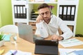 Young hispanic man call center agent working tired sleeping at office Royalty Free Stock Photo